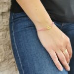 bracelet cordon rose cauris doré